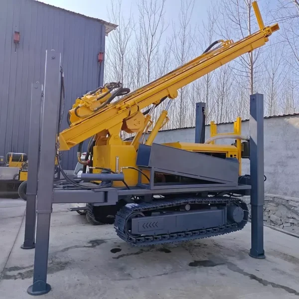 Yellow hydraulic drilling rig mounted on tracks, positioned on a concrete surface.